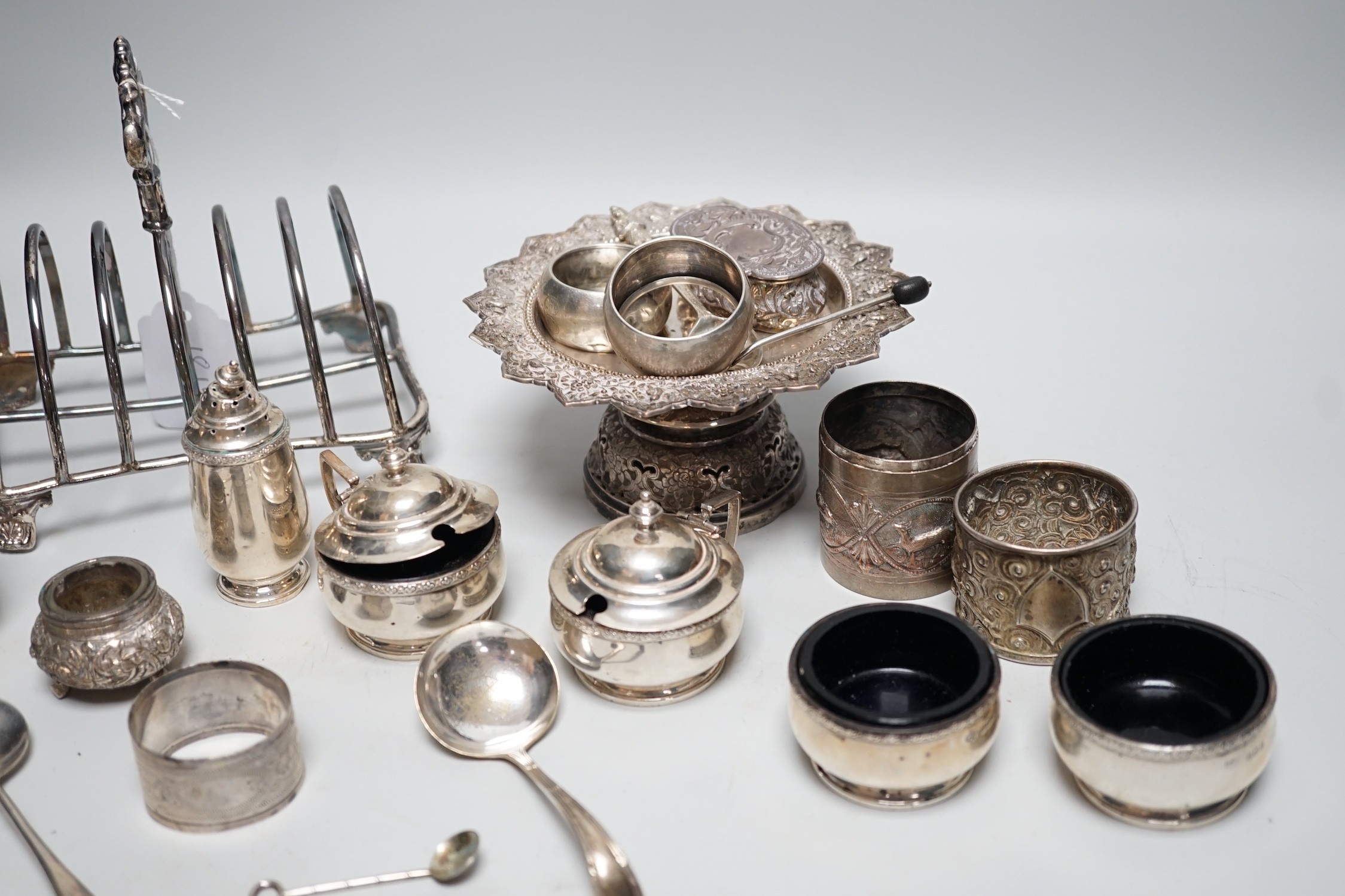 A George IV silver seven bar toast rack, by Robinson, Edkins & Aston, Birmingham, 1827, length 15.7cm, a George V silver six piece condiment set, Mappin & Webb, Birmingham, 1929, a silver coffee spoon and repousse box, t